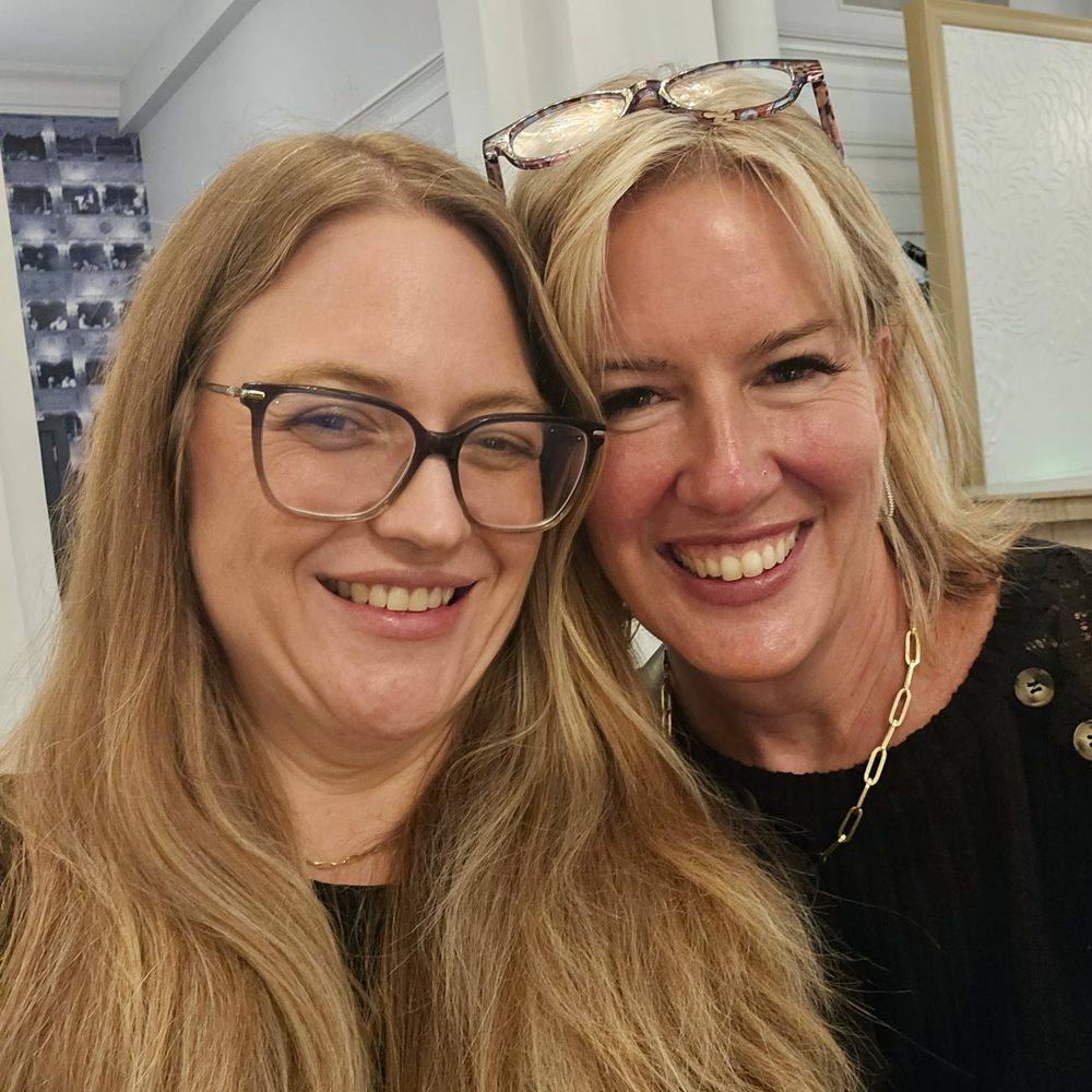 Jess Morris and Jessica Barclay of ThrIVe Wheeling smiling together in a hotel lobby