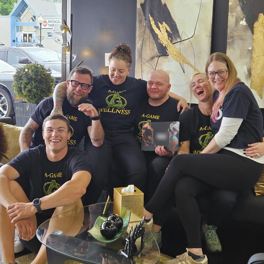 Jess Morris laughing with the A-Game Wellness team in their lobby